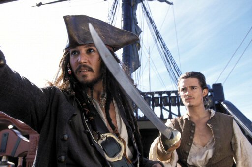 Johnny Depp as Captain Jack Sparrow and Orlando Bloom as Will Turner in Pirates of the Caribbean The Curse of the Black Pearl (2003).