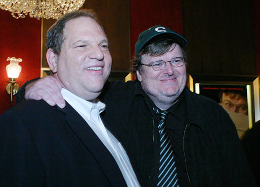 Harvey Weinstein, co-founder of Miramax Films, and Michael Moore pose for photographers during a special screening of Moore's film 'Fahrenheit 9/11,' New York, June 14, 2004.