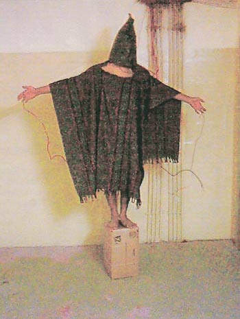 A hooded and wired Iraqi prisoner is seen at the Abu Ghraib prison near Baghdad, Iraq in this undated photo released on April 30, 2004.