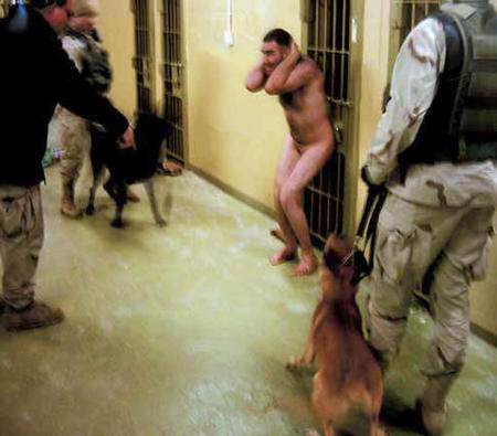 Unidentified U.S. soldiers surround an Iraqi detainee in this photo obtained by The New Yorker said to be taken in December 2003, at the Abu Ghraib prison in Baghdad, Iraq and released on May 9, 2004.