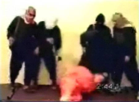 A frame grab taken from an Islamist website video footage shows an American civilian, who identified himself as Nick Berg of Philadelphia, kicked to the floor and beheaded by one of his five masked captors, whom said by the website to be Abu Musab aZarqawi, Al Qaeda's leader in Iraq, May 11, 2004.