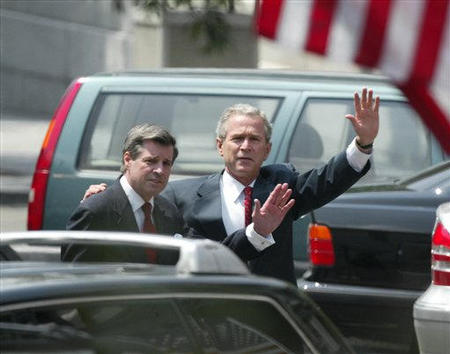 President George W. Bush walks with his arm around former US administrator in Iraq L. Paul Bremer III, to a meeting with Iraqi-Americans in the Eisenhower Old Executive Office Building across from the White House, Washington, June 30, 2004.
