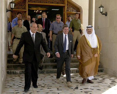Prime Minister Iyad Allawi, left, US administrator L. Paul Bremer III, center, and Iraqi President Ghazi al-Yawer make their farewells, Baghdad, Iraq, June 28, 2004.