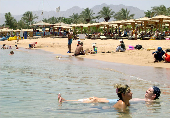 Just a day after the explosions, beaches are crowded with sunbathers, except in front of one hotel that had been all but obliterated by the attack, Sharm A-Sheik, July 25, 2005.