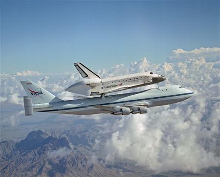 Space shuttle Discovery rides piggyback atop a specially modified Boeing 747 on its ferry flight from California to the Kennedy Space Center, Florida, August 19, 2005.