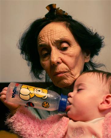 Adriana Iliescu, 67, celebrates the first birthday of her daughter Eliza-Maria in her apartment in Bucharest, Romania, January 16, 2006.