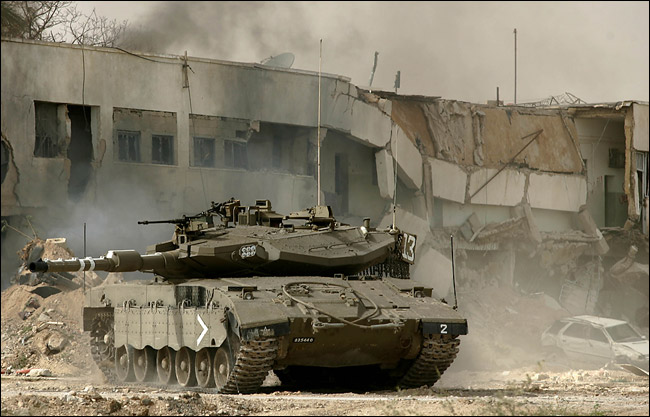 Using tanks and bulldozers, Israeli military forces lay siege to a Palestinian prison with the intent of seizing six Palestinian inmates who have been held under an unusual arrangement that also involved the U.S. and Britain, Jericho, March 14, 2006.