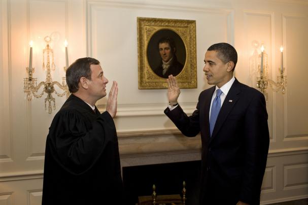 Chief Justice John G. Roberts Jr. administers the Barack Hussein Obama's oath of office for a second time in the Map Room of the White House, January 21, 2009.