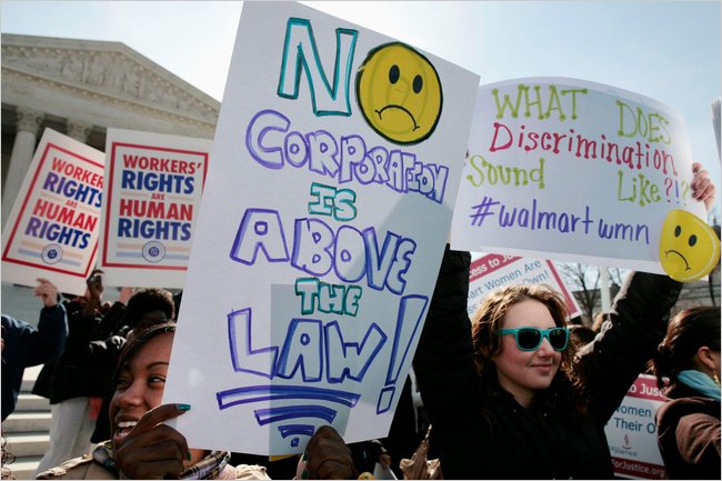 Protesters rally in front of the Supreme Court to show their support for female workers suing Walmart, the enormous employment discrimination class-action suit against Walmart that seeks billions of dollars on behalf of as many as 1.5 million female workers (but later in June 20 was thrown out by the justices), Washington, D.C., March 2011.