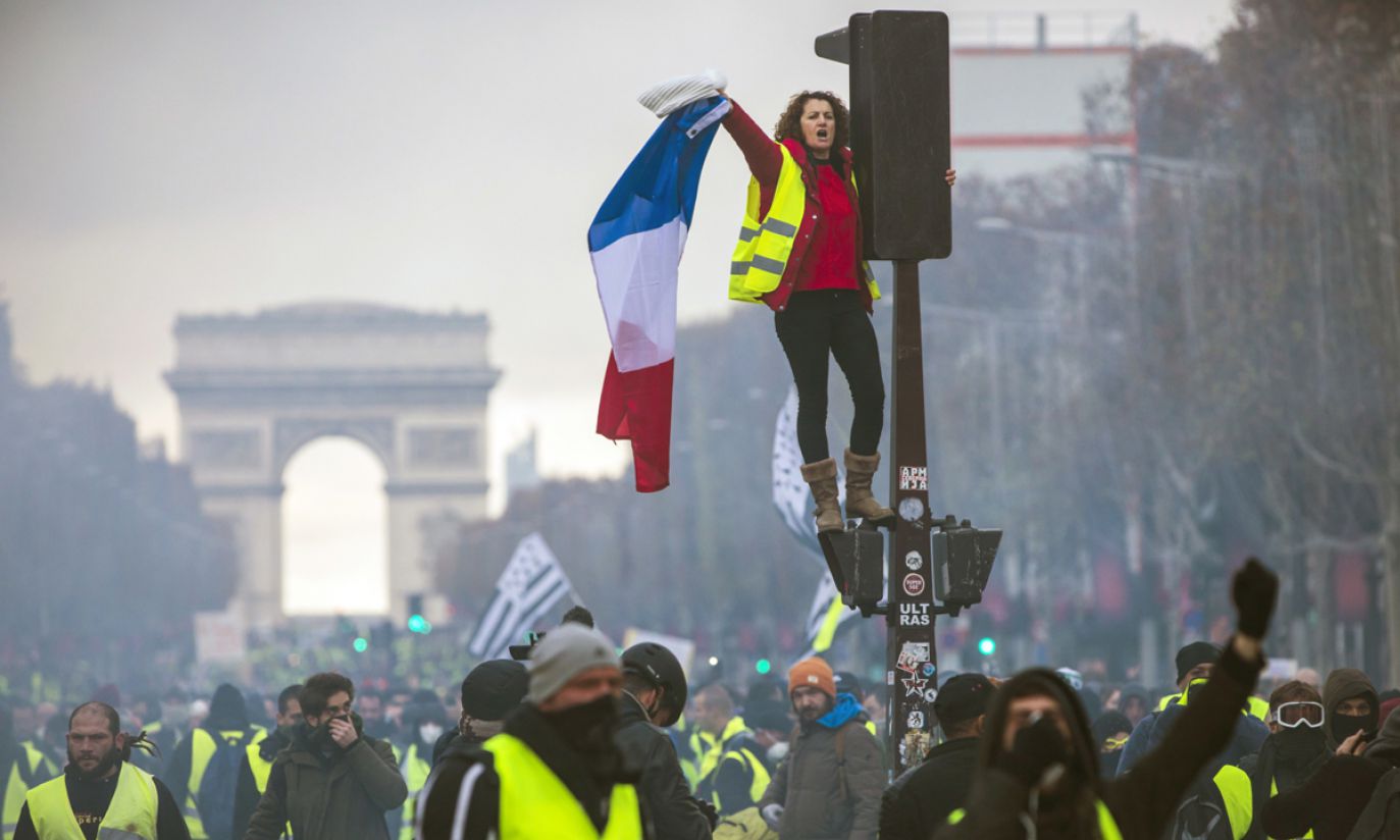 The famed Champs-Elyses avenue speckles in neon as protesters holding flags of France and Brittany don "gilets jaunes' (yellow vests), the French drivers required to keep in their vehicles and become a sort of uniform for the movement against higher fuel costs, Paris, November 24, 2018.