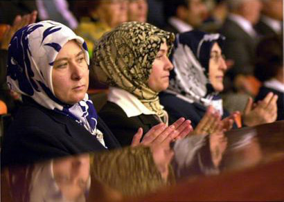 Wives and supporters applaud new deputies of Islamic-rooted Justice and Development Party (AKP) taking their oath, Turkey's new parliament first session, Ankara, November 14, 2002.