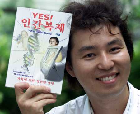 Clonaid Korea spokesman Kwak Gi-hwa holds a book titled 'Yes to Human Cloning' during an interview, Seoul, July 25, 2002.