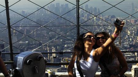 Two German women take a picture of themselves atop the Empire State Building, New York, September 7, 2002.