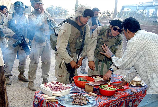 Soldiers bought kebab sandwiches from a street vendor, Baghdad, April 17, 2003.