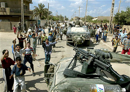 Young Iraqis greeted soldiers patrolling a Baghdad neighborhood. They were members of the Third Battation, 187th Regiment, of the 101st Airborne, or Screaming Eagles, April 18, 2003.