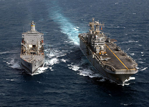 The USS Tarawa, right, receives fuel during an underway replenishment with Military Sealift Command Oiler USNS Yukon, somewhere in the gulf region, April 7, 2003.