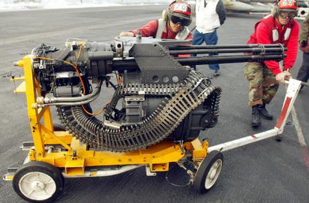Ordnance specialists convey a M61A1 Vulcan cannon, a six-barrel 20mm gun capable of firing 6, 600 rounds per minute, the flight deck of the USS Harry S. Truman, April 6, 2003.