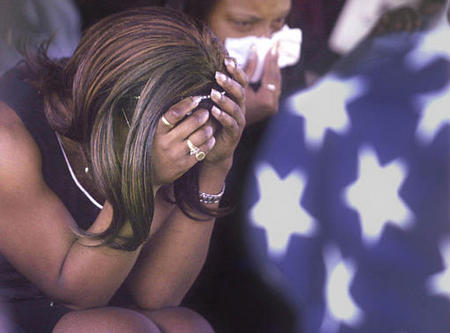 Family members mourn by the casket of Marine Lance Cpl. Brian E. Anderson, Durham, North Carolina, during funeral services for the Camp Lejeune Marine, April 15, 2003. Anderson was killed in Iraq on April 2.