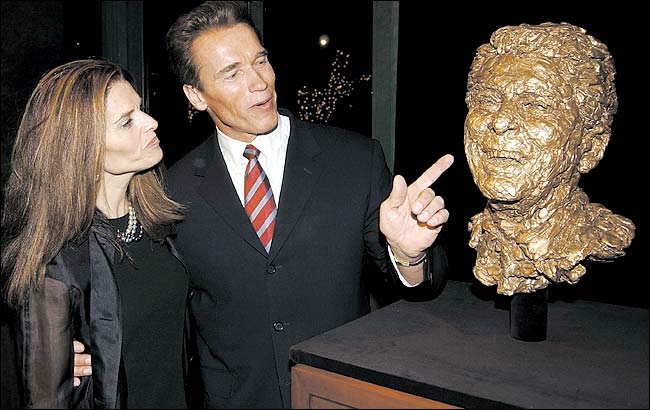 Arnold Schwarzenegger and his wife, Maria Shriver, admire a bronze sculpted bust of President Ronald Reagan, done by artist Robert Berks, was commisioned by Schwarzenegger, after its unveiling at the Ronald Reagan Presidential Library and Museum, Simi Valley, California, March 20, 2002.