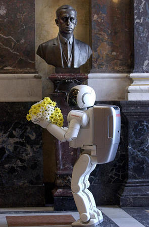Japanese Prime Minister Junichiro Koizumi applauds while his Czech counterpart Vladimir Spidla shakes hands with the humanoid robot Asimo Honda presented by Koizumi, Hrzansky Palace, Prague, August 21, 2003.