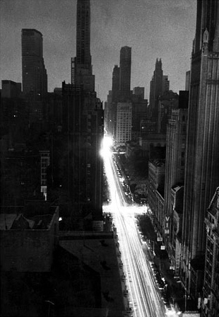 Lights of moving automobiles crossing Midtown Manhattan looking east along 42nd Street from Times Square, during the major blackout of November 1965.