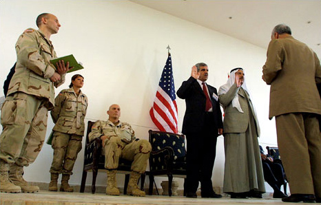 A Kurd, Abdul Rahman Mustapha, third from right, was sworn in as mayor of Kirkuk, and an Arab, Ismail al-Hadid, second from right, took the oath as his deputy, Kirkuk, May 28, 2003.