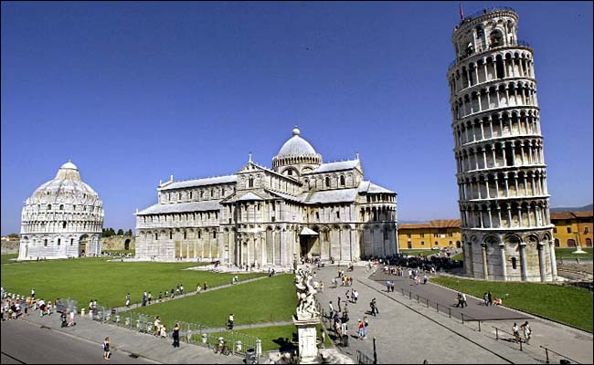 The Leaning Tower of Pisa, shown with cathedral and baptistery, Tuscany, August 2003.