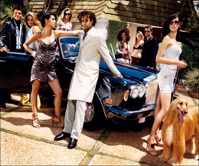 Models gather around a Rolls Royce car, New York, August 2003.