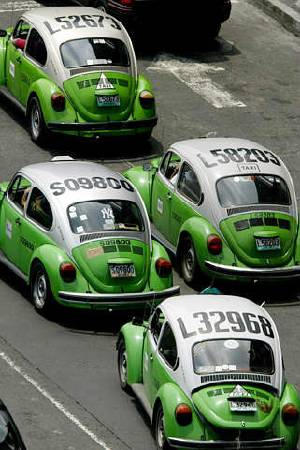 Volkswagen Beetle taxis drive through Mexico City, July 8, 2003.