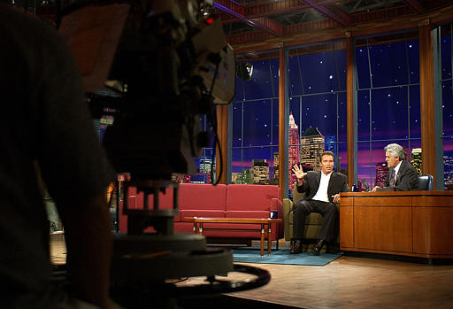 Actor Arnold Schwarzenegger talks with host Jay Leno after announcing his intentions to run for Governor of California during taping of The Tonight Show with Jay Leno, Burbank, California, August 6, 2003.