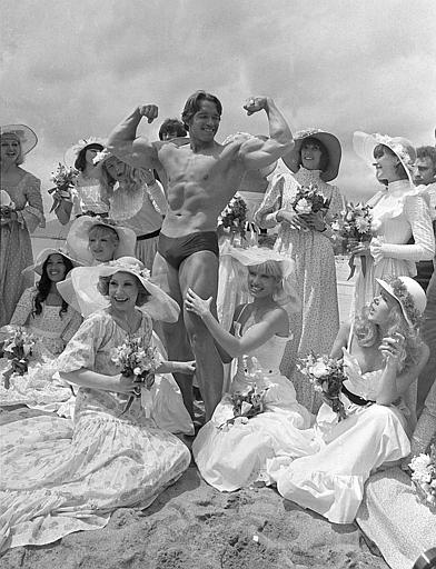 Arnold Schwarzenegger is seen showing off his body for an appreciative beach audience, where his documentary 'Pumping Iron' was being presented at the Cannes Film Festival, Cannes, France, May 20, 1977.