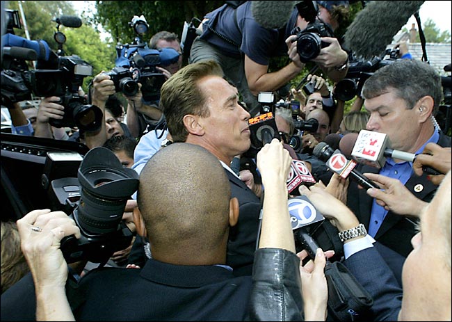 Arnold Schwarzenegger was swarmed by reporters after voting at the polling station, Pacific Palisades, California, October 7, 2003.