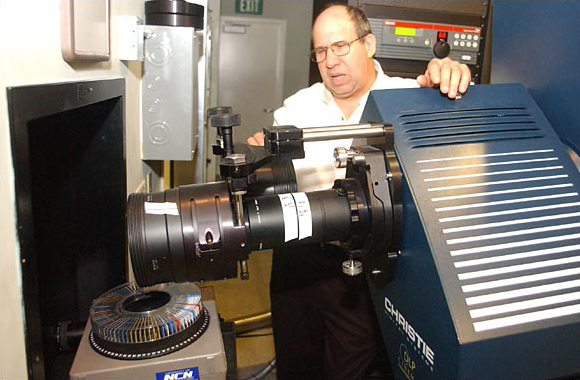 Mark Kahn, a Pacific Theaters engineer, with a digital projector, October 2003.
