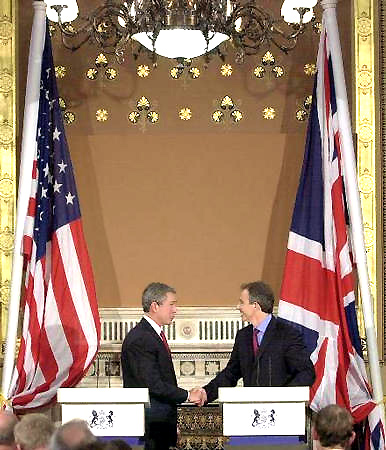 US President George W. Bush and British Prime Minister Tony Blair shake hands at their joint press conference at the Foreign and Commonwealth Offices, London, November 20, 2003.