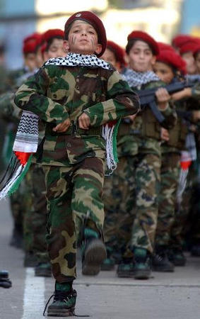 A young boy's unit of Hezbollah group take part in a military parade to mark Al-Quds Day (Jerusalem Day), suburb south of Beirut, Lebanon, November 21, 2002.