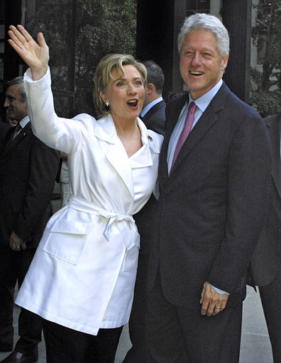 Senator Hillary Rodham Clinton waves as she arrives with her husband, former U.S. President Bill Clinton, to her official book party for her memoir 'Living History,' New York, June 16, 2003.