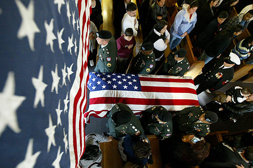 The body of Army Pfc. Karina Lau, who died on November 2, along with 15 other U.S. soldiers when their helicopter was down, is carried out of St. Jude Thaddeus Catholic Church in Livingston, California, November 12, 2003.