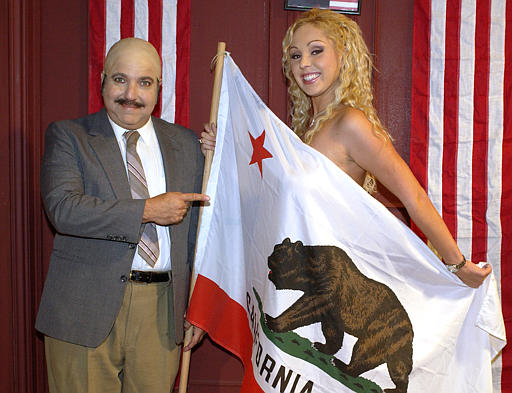 Adult film actors Ron Jeremy and Mary Carey pose on the set of their adult film Run Mary Run, Los Angeles, November 2, 2003.