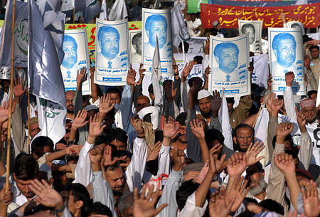 Opposition supporters raised their hands to praise Pakistani nuclear scientist Abdul Qadeer Khan at a rally, Karachi, Pakistan, February 5, 2004.