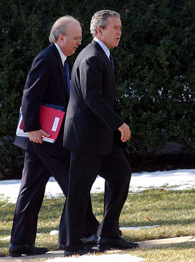 President George W. Bush walks to the Oval Office of the White House with presidential advisor Karl Rove, after returning from Republican National Committee luncheon, February 4, 2004.