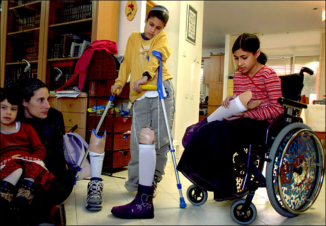 As reported by the New York Times from Kfar Darom settlement in January 2004, Noga Cohen, left, wants to stay in her isolated settlement despite an attack three years ago that maimed three of her children: Tehila, right, now 12, lost both legs; Israel, 10, lost a leg; another daughter lost a foot.