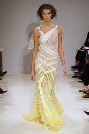 A model presents a white and yellow see-through and sleeveless cotton evening gown designed by British fashion designer Julien McDonald for Givenchy's spring summer 2004 haute couture collection, Paris, January 20, 2004.