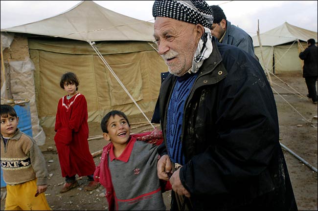 Driven from the northern Iraqi city of Kirkuk more than a decade ago by Saddam Hussein's government, 130 Kurdish families have now returned to the area to demand political power and reparations for seized property, but they still live in a muddy field of green canvas tents propped up on the city's edge, the floors damp with rainwater, the interiors warmed by small kerosene heaters, January 2004.
