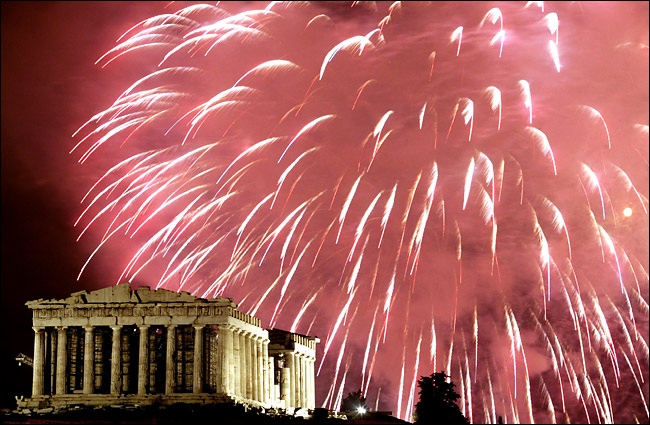 Fireworks illuminate the ancient Parthenon atop the Acropolis Hill at the start of the New Year, Athens, January 1, 2004.