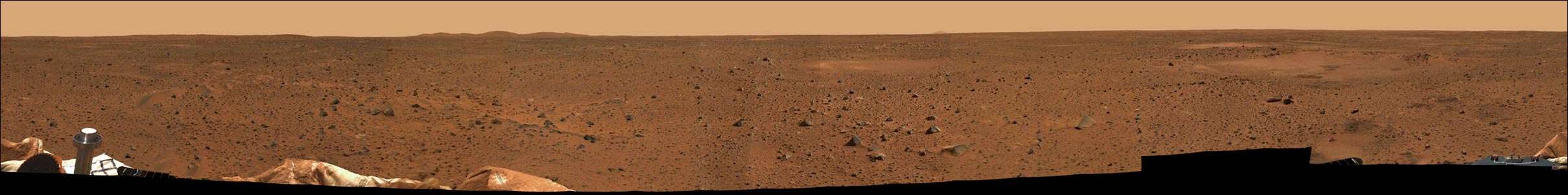 The first 360-degree color view of Mars from the Spirit rover. The panorama is a composite of 225 images taken over three days and radioed back to Earth. The craft can be seen in the lower corners. Picture was released January 12, 2004.