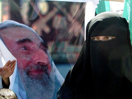 A Hamas supporter attends the funeral of Hamas spiritual leader Ahmed Yassin, during his funeral procession, Gaza City, March 22, 2004.