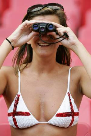 A supporter wearing an England's Saint George flag bra watches from the stands ahead of their Euro 2004 Group B soccer match against Croatia at the Luz Stadium in Lisbon, June 21, 2004.