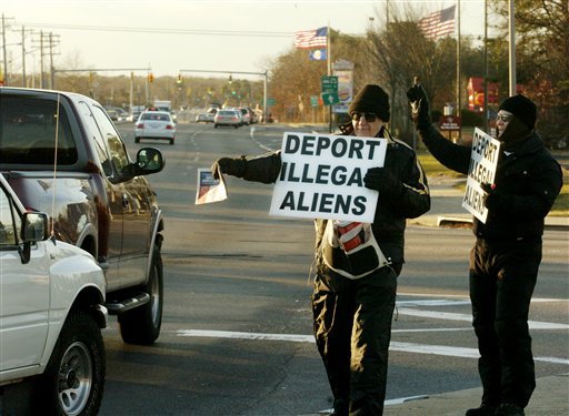 Protesters hand out flyers on a street corner in Farmingville, New York, one of several Long Island communities that have been beset by tensions over an influx of illegal immigrants, January 7, 2004.