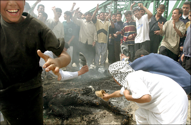 Iraqis cheered while bodies burned and mutilated after an attack on American civilians working for Blackwater Security Consulting of Moyock, North Carolina, Fallujah, Iraq, March 31, 2004.