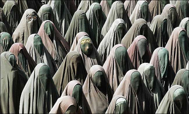 Iraqi women who belong to a Shiite militia, the Mahdi Army, marched to protest the American occupation of Iraq, impoverished suburb of Sadr City, Baghdad, April 3, 2004.